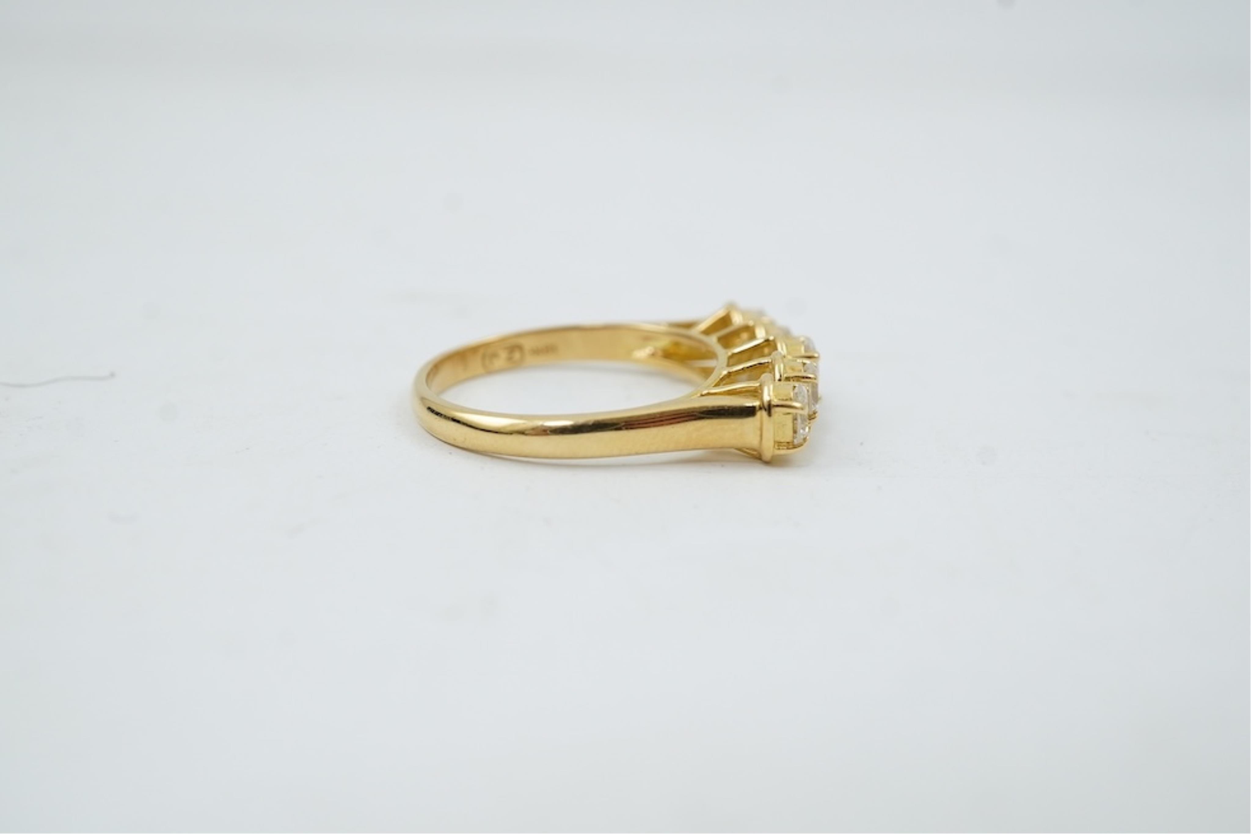 A modern 18ct gold and five stone oval cut diamond set half hoop ring, size N, gross weight 3.8 grams.
